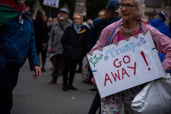 September 17, 2025, London, England, United Kingdom: A protestor holds a placard during the Trump not welcome demonstration at Parliament Square. Around 50 protest groups were expected to gather toget ...