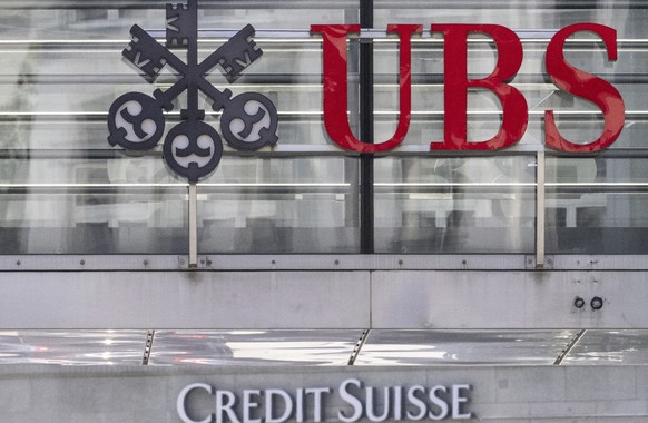 The logos of the Swiss banks Credit Suisse and UBS are pictured in Zurich, Switzerland, June 12, 2023. UBS says it has completed its takeover of embattled rival Credit Suisse. The announcement comes n ...