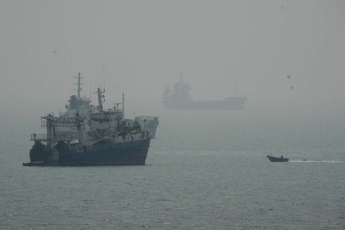 A motorboat travels past commercial vessels anchored amid haze in the Strait of Hormuz off Bandar Abbas, Iran, Monday, Sept. 7, 2026. (AP Photo/Vahid Salemi)
Iran War Strait of Hormuz