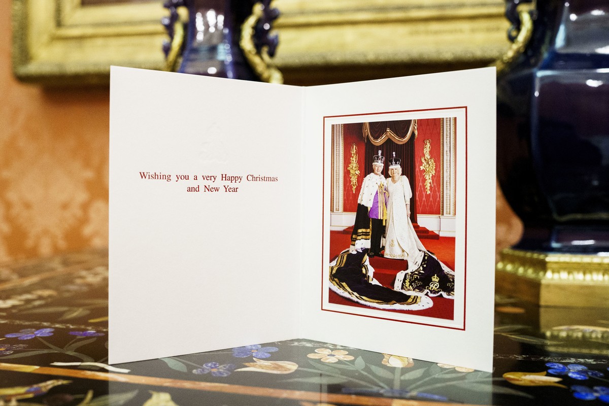 This undated photo released by Buckingham Palace shows the 2023 Christmas card of Britain's King Charles III and the Queen Camilla at Buckingham Palace, London. The photograph was taken in the Th ...