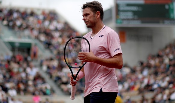 epa09969350 Stan Wawrinka of Switzerland plays Corentin Moutet of France in their men?s first round match during the French Open tennis tournament at Roland ?Garros in Paris, France, 23 May 2022.. Sta ...