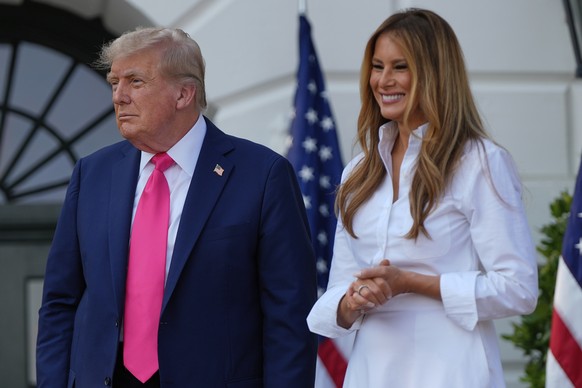 President Donald Trump and first lady Melania Trump watch before Trump signs his signature bill of tax breaks and spending cuts at the White House, Friday, July 4, 2025, in Washington. (AP Photo/Julia ...
