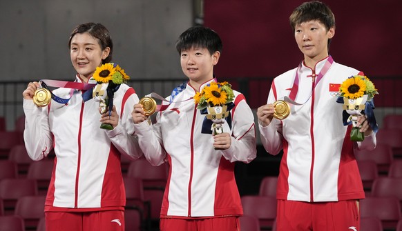 From left, gold medalists Chen Meng, Sun Yingsha, and Wang Manyu of China pose with their medals during the medal ceremony for women&#039;s team table tennis at the 2020 Summer Olympics, Thursday, Aug ...