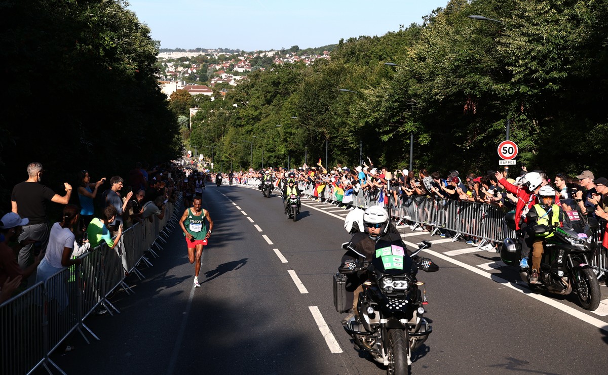 epa11541674 Tamirat Tola of Ethiopia (L) competes during the Men's Marathon event of the Athletics competitions in the Paris 2024 Olympic Games in Paris, France, 10 August 2024. EPA/ANNA SZILAGYI