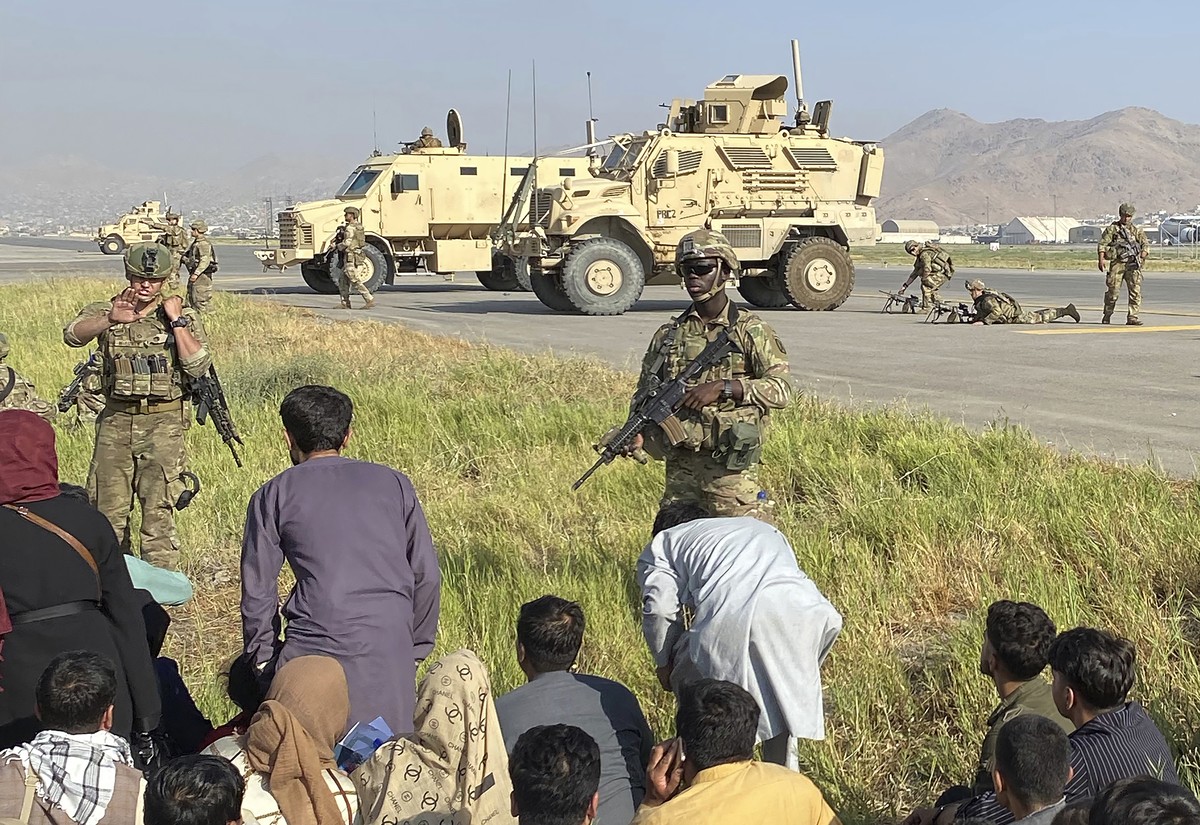 U.S soldiers stand guard along a perimeter at the international airport in Kabul, Afghanistan, Monday, Aug. 16, 2021. On Monday, the U.S. military and officials focus was on Kabul's airport, wher ...