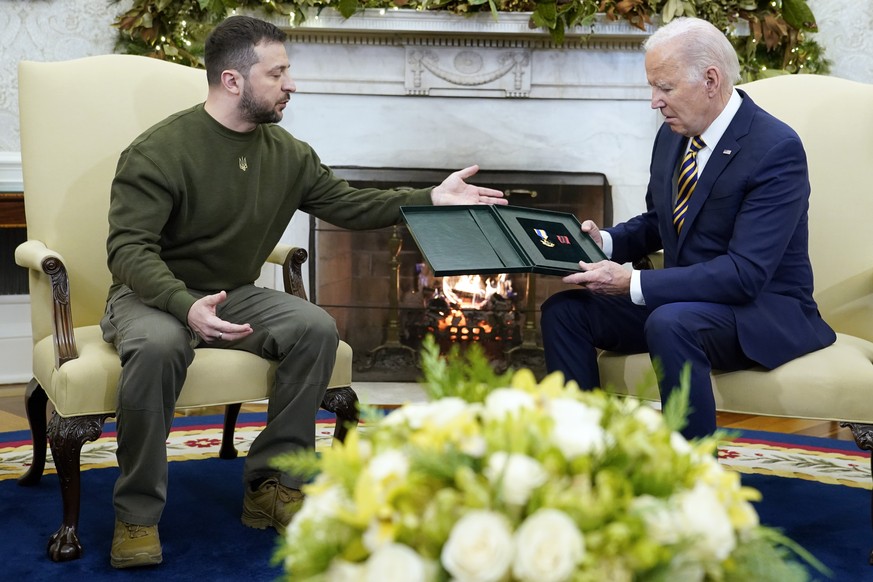Ukrainian President Volodymyr Zelenskyy speaks after giving President Joe Biden a gift as they meet in the Oval Office of the White House, Wednesday, Dec. 21, 2022, in Washington. (AP Photo/Patrick Se ...