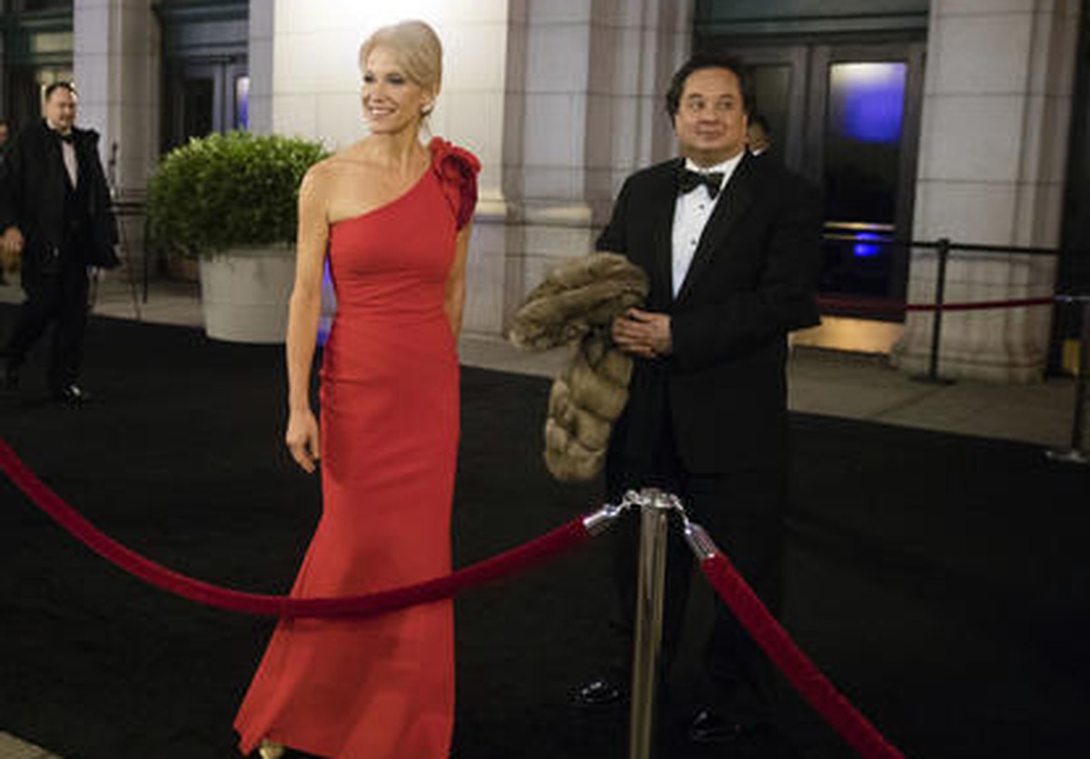 FILE - In this Thursday, Jan. 19, 2017 file photo, President-elect Donald Trump adviser Kellyanne Conway, center, accompanied by her husband, George, speaks with members of the media as they arrive fo ...