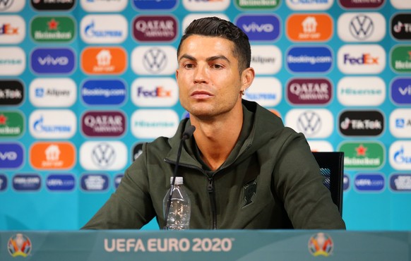 epa09275477 A handout photo made available by the UEFA shows Portugal&#039;s Cristiano Ronaldo with a bottle of water during the Portugal Press Conference ahead of the UEFA Euro 2020 Group F match bet ...