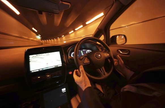 Nissan Motor Co. General Manager Tetsuya Iijima gets his hands off of the steering wheel of a self-driving prototype vehicle during a test drive in Tokyo, Tuesday, Nov. 3, 2015. Nissan&#039;s &quot;in ...