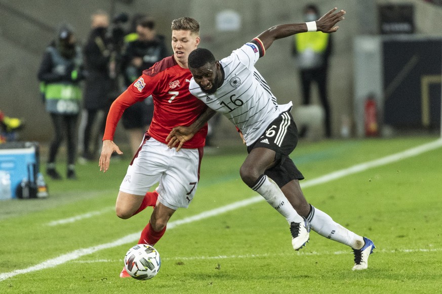 epa08742079 Switzerland&#039;s Cedric Itten (L) fights for the ball against Germany&#039;s Antonio Ruediger during the UEFA Nations League group stage, League A, group 4 soccer match between Germany a ...