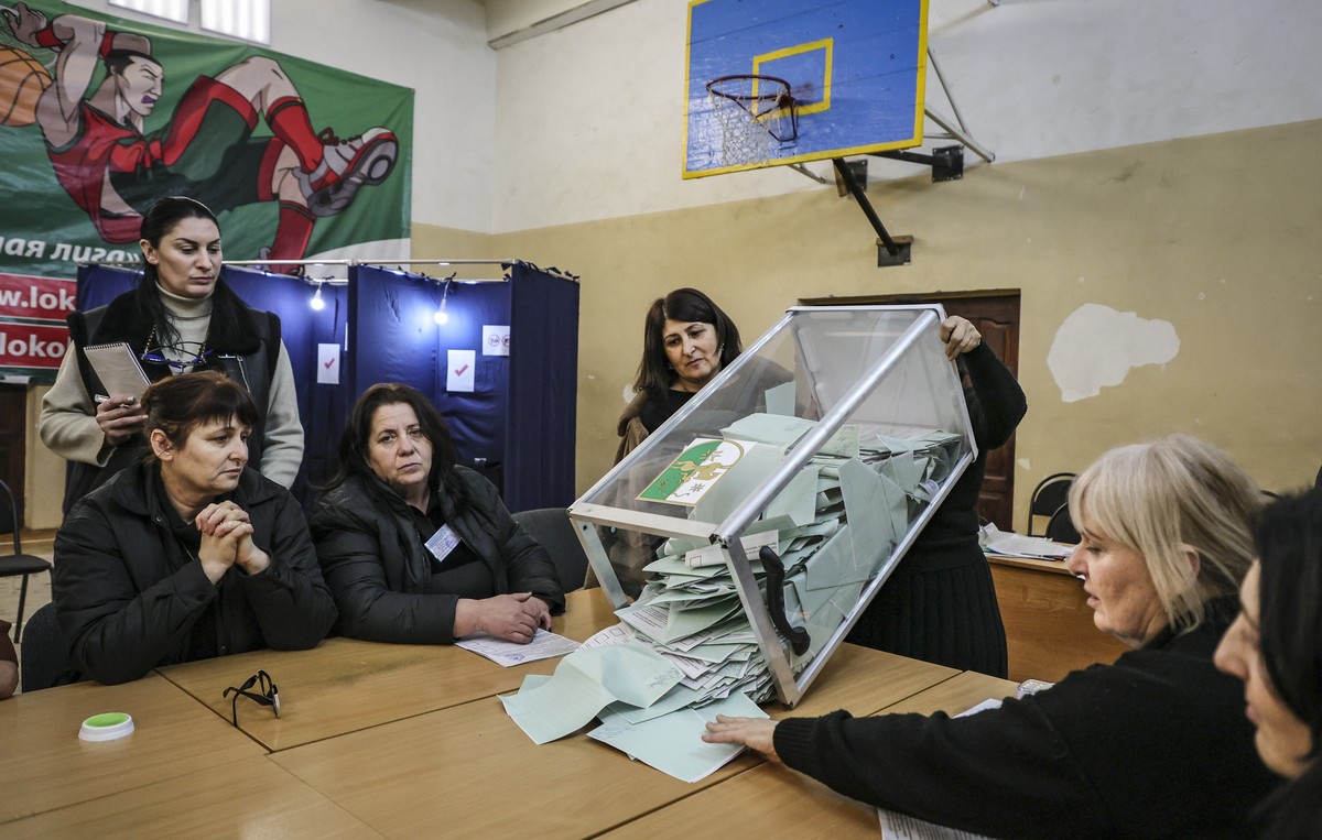 epa11898807 Members of the local elections commission count ballots at the polling station after end of the early presidential elections in Sukhumi, the capital of the self-proclaimed republic of Abkh ...