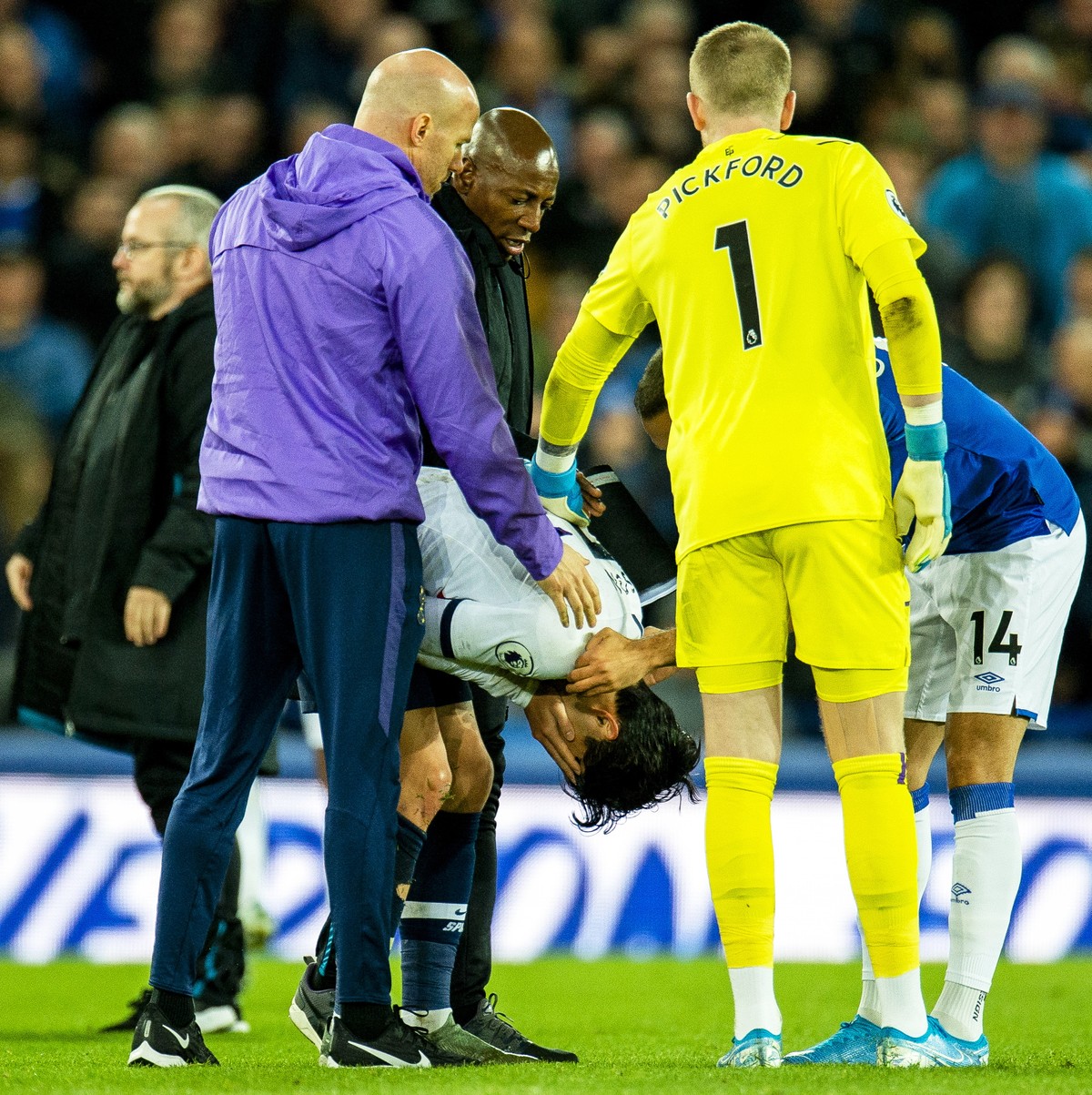 epa07970271 Tottenham Hotspur's Son Heung-min (C) reacts after tackling Everton's Andre Gomes causing an injury to the Everton player during the English Premier League soccer match between E ...
