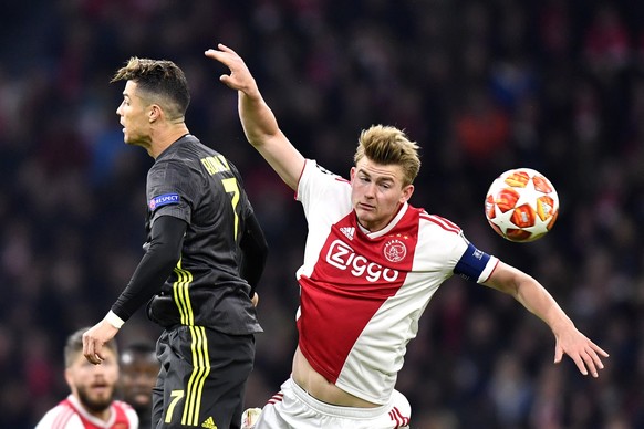 Juventus&#039; Cristiano Ronaldo, left, and Ajax&#039;s Matthijs de Ligt jump for the ball during the Champions League quarterfinal, first leg, soccer match between Ajax and Juventus at the Johan Cruy ...