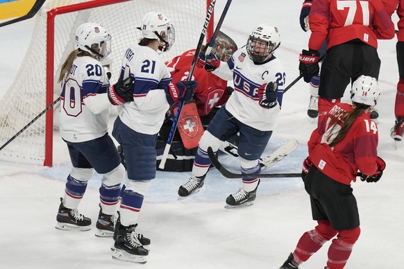 United States&#039; Hilary Knight (21) is congratulated by Hannah Brandt (20) and Kendall Coyne Schofield (26) after scoring a goal against Switzerland during a preliminary round women&#039;s hockey g ...