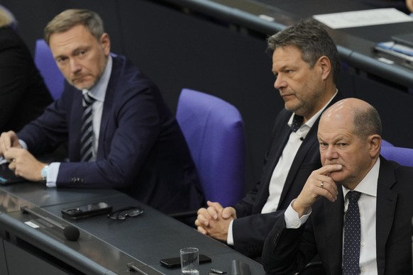 From right, German Chancellor Olaf Scholz, Economy and Climate Minister Robert Habeck and Finance Minister Christian Lindner listen to a debate about Germany&#039;s budget crisis at the parliament Bun ...