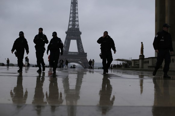 French police officers patrol on the esplanade of the Trocadero in Paris, France Sunday, May 7, 2017. Security was high as voters across France vote for a new president in an unusually tense and impor ...