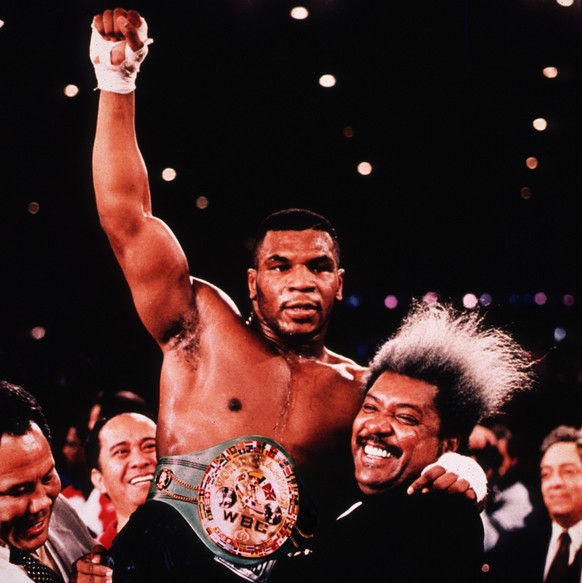 FILE--Boxer Mike Tyson is held high by promoter Don King after knocking out Tervor Berbick to become the youngest heavyweight champion in this Nov. 22, 1986 file photo in Las Vegas. William Eaddy, 33, ...