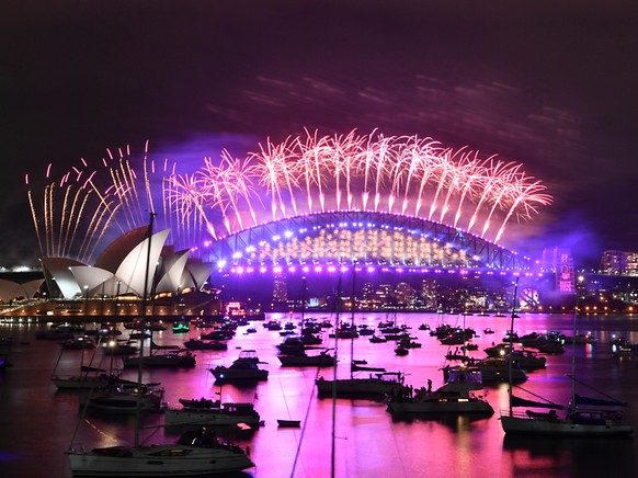 The midnight fireworks light up Sydney Harbour and the Sydney Harbour Bridge during New Yearâs Eve celebrations in Sydney, Friday, December 11, 2020. Sydneysiders were asked to stay home and watch t ...