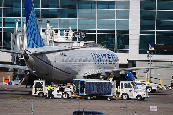 Tugs deliver baggage to a United Airlines jetliner as it waits for departure from a gate on the A concourse of Denver International Airport, Tuesday, Nov. 25, 2025, in Denver. (AP Photo/David Zalubows ...