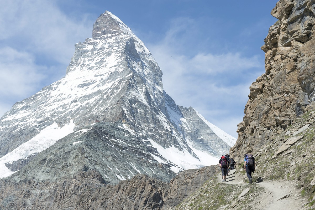 epa04322639 Hikers walk toward the Matterhorn Mountain in Zermatt, Switzerland, 19 July 2014. The same day the 'Base Camp Matterhorn' opened its tent camp, which until 15 September 2014 serv ...