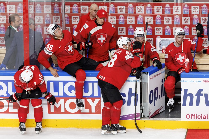 Switzerland&#039;s forward Andres Ambuehl #10, Switzerland&#039;s defender Michael Fora #45, Switzerland&#039;s goaltender Leonardo Genoni, 3rd left, Switzerland&#039;s forward Christoph Bertschy #88, ...