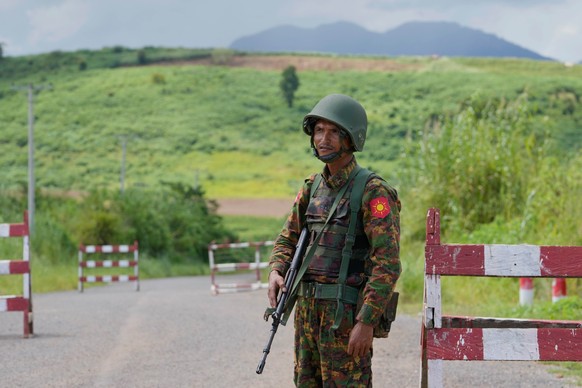 In this photo taken during a trip organised by pro-military Myanmar media, a soldier keeps guard at a check point in Kyaukme, northern Shan State, Myanmar, Friday, Oct. 10, 2025. (AP Photo/Aung Shine  ...