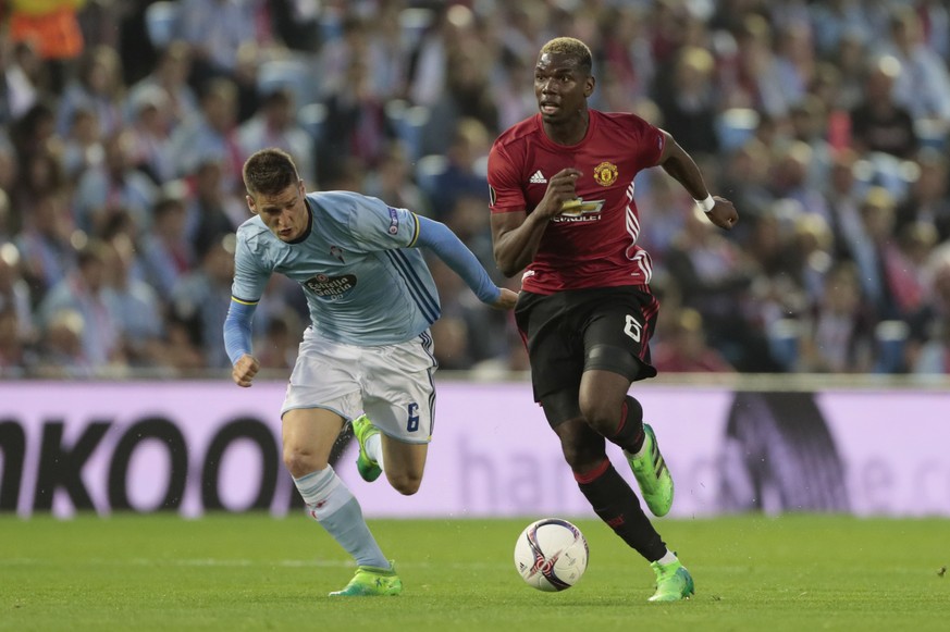 Manchester United&#039;s Paul Pogba, right, controls the ball as he runs past Celta&#039;s Nemanja Radoja during a Europa League, semifinal, first leg soccer match between Celta and Manchester United  ...