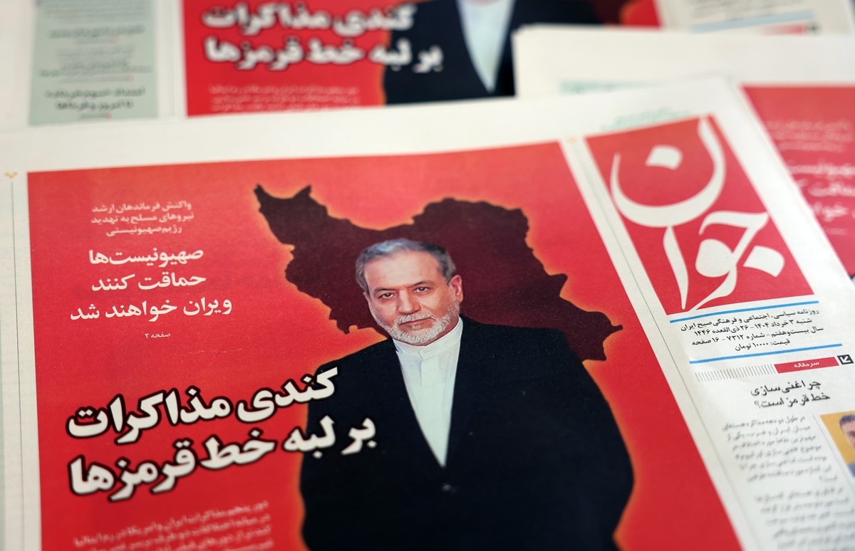 epa12129870 Copies of the Iranian daily newspaper Javan entitled 'The slowdown negotiations over the edge of red lines' carrying a picture of Iranian Foreign Minister Abbas Araghchi, in a ki ...