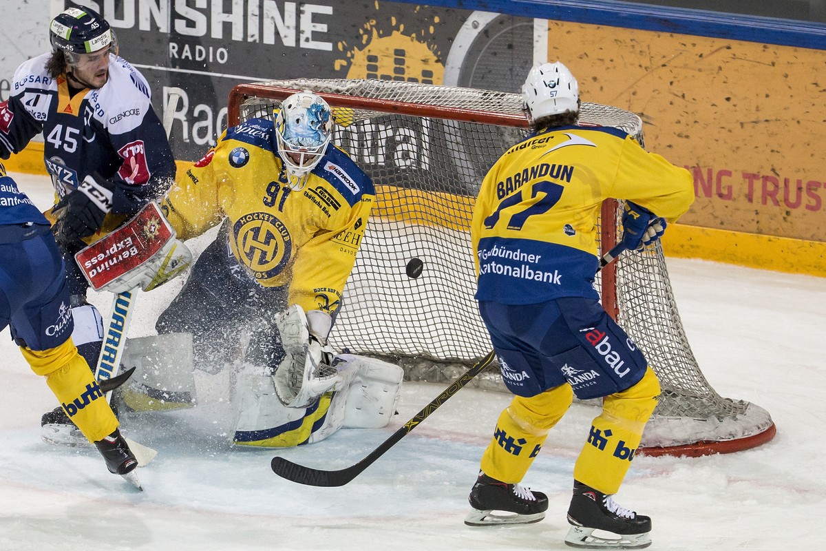 Zugs Dennis Everberg, Davos'Goalie Gilles Senn und Davos' Davyd Barandun, von links, im Eishockey Meisterschaftsspiel der National League zwischen dem EV Zug und dem HC Davos am Samstag, 8.  ...