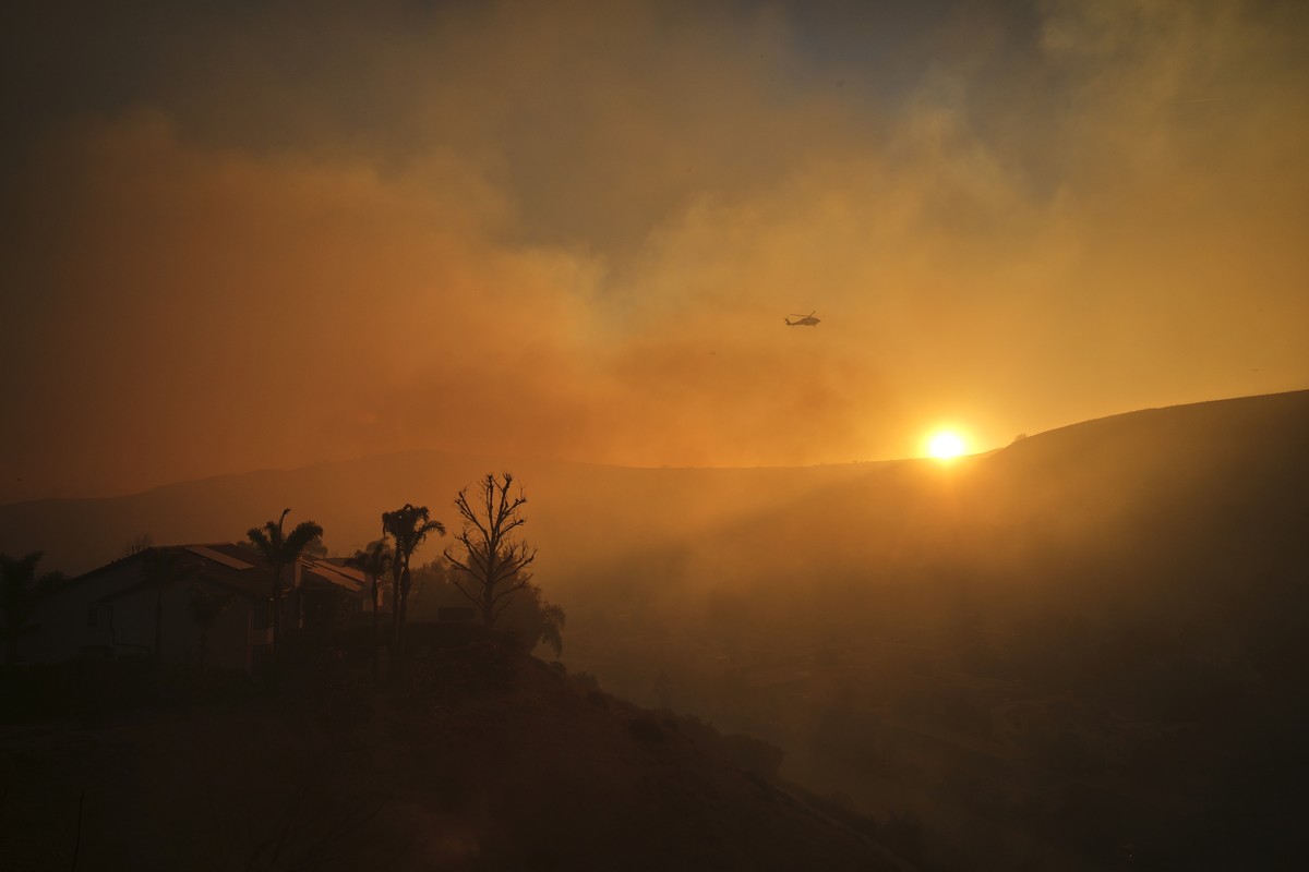 A helicopter flies over the Kenneth Fire, Thursday, Jan. 9, 2025, in the West Hills section of Los Angeles. (AP Photo/Eric Thayer)