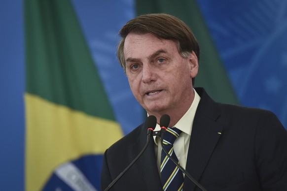 Brazil&#039;s President Jair Bolsonaro speaks to journalists about the new coronavirus at Planalto presidential palace in Brasilia, Brazil, Friday, March 27, 2020. Even as the new coronavirus cases mo ...