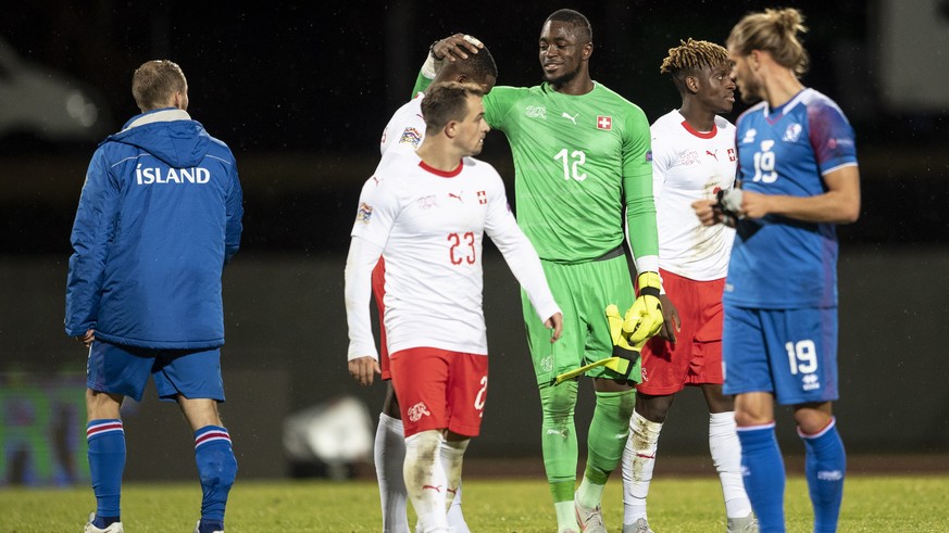 epa07095912 Switzerland&#039;s goalkeeper Yvon Mvogo (C) and teammate Xherdan Shaqiri (2-L) react after the UEFA Nations League soccer match between Iceland and Switzerland at the Laugardalsvoellur st ...