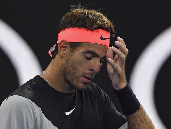 Argentina&#039;s Juan Martin del Potro wipes the sweat from his face during his third round match against Tomas Berdych of the Czech Republic at the Australian Open tennis championships in Melbourne,  ...