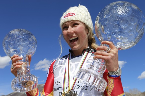 World Cup overall women&#039;s 2017 champion United States&#039; Mikaela Shiffrin smiles as she holds up a crystal globe trophies after a World Cup skiing race Sunday, March 19, 2017, in Aspen, Colo.  ...