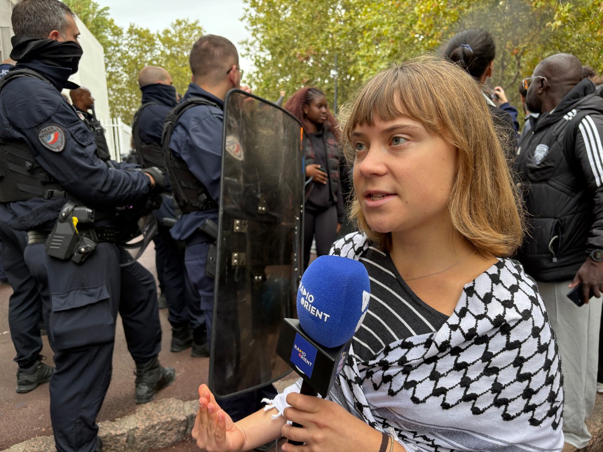 Activist Greta Thunberg answers journalist's questions as she attends a gathering in front of the Paul Eluard high school during a protest against under-resourced schools in Saint-Denis, outside  ...