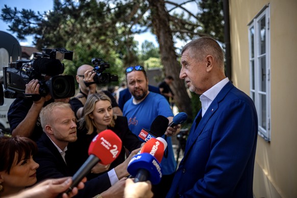 epa11395445 Former Czech prime minister and ANO (Yes) opposition movement leader, Andrej Babis (R), speaks to the media after casting his vote at a polling station during the European elections in Pru ...