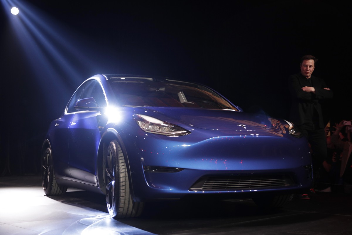 Tesla CEO Elon Musk, right, stands next to the Model Y at Tesla's design studio Thursday, March 14, 2019, in Hawthorne, Calif. The Model Y may be Tesla's most important product yet as it att ...