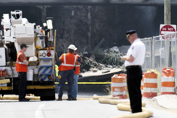 Officials are working on the scene after a collapse on I-95 following a truck fire, Sunday, June 11, 2023 in Philadelphia.  (AP Photo/Joe Lamberti)