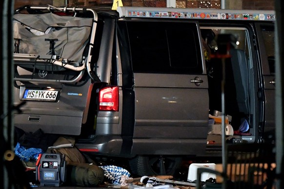 epa06653896 A view of crime scene with the vehicle after an attack in the inner city of Muenster, Germany, 08 April 2018. According to the police, a man drove a van into a crowd of people in the city  ...