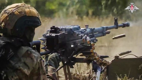 In this photo taken from video distributed by Russian Defense Ministry Press Service on Sunday, Aug. 17, 2025, a Russian soldier fires during a practice at a training ground on an undisclosed location ...