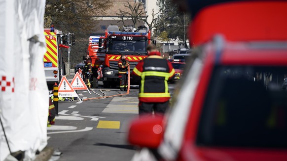 Firefighters on the street close to a villa where bodies were found after a fire, in Yverdon-les-bains, Switzerland, Thursday, March 9, 2023. An explosion followed by a fire took place Thursday mornin ...