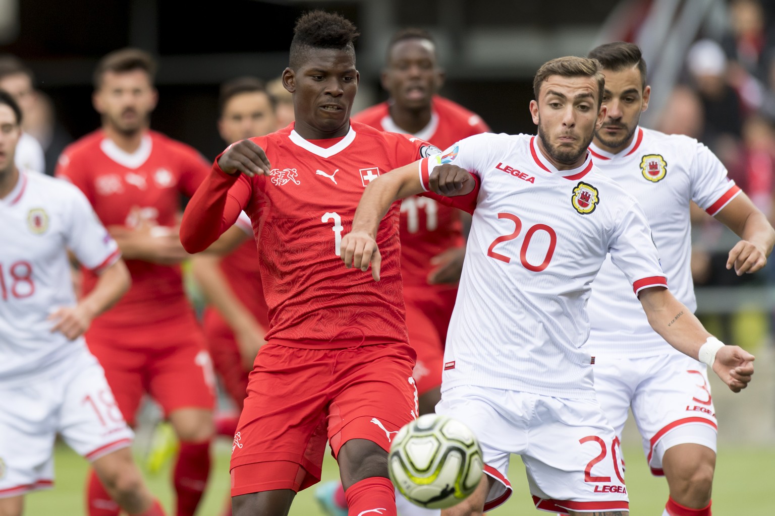 Switzerland&#039;s forward Breel Embolo, left, fights for the ball with Gibraltar&#039;s midfielder Ethan Britto, right, during the UEFA Euro 2020 qualifying Group D soccer match between the Switzerla ...