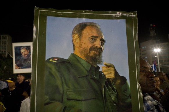 A picture of Fidel Castro is held during a rally honoring the late Cuban leader at the Revolution Plaza in Havana, Cuba, Tuesday, Nov. 29, 2016. Schools and government offices were closed Tuesday for  ...
