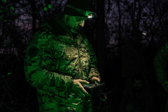 epa12501029 A pilot from the Predator Brigade&#039;s unmanned vehicle unit of the Ukrainian Patrol Police in Donetsk prepares to launch a GARA bomber drone on a nighttime strike mission against Russia ...