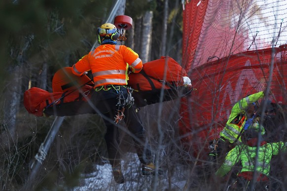 FILE - Medical staff are carrying France&#039;s Cyprien Sarrazin after crashing into protections net during an alpine ski, men&#039;s World Cup downhill training, in Bormio, Italy, on Dec. 27, 2024. ( ...