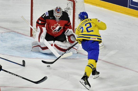 Canada&#039;s Calvin Pickard blocks a shot by Sweden&#039;s Joel Eriksson Ek, right, at the Ice Hockey World Championships final match between Canada and Sweden in the LANXESS arena in Cologne, German ...