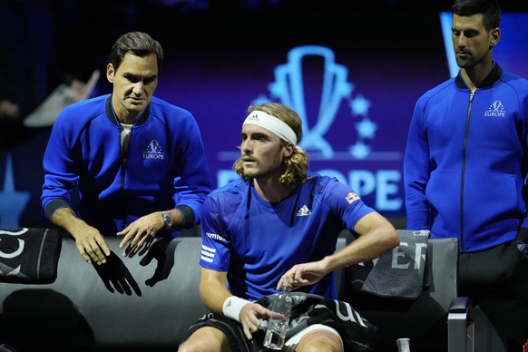 Europe's Stefanos Tsitsipas, center, talks to his teammate Roger Federer of Switzerland during a match on day one of the Laver Cup tennis tournament at the O2 in London, Friday, Sept. 23, 2022. (AP Ph ...