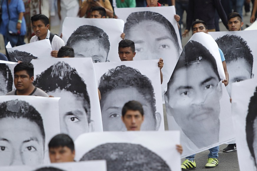 epa06695794 Students and relatives of the 43 students, which went missing in Ayotzinapa, march through the streets during a protest in the municipality of Iguala, Guerrero, Mexico City, Mexico, 26 Apr ...