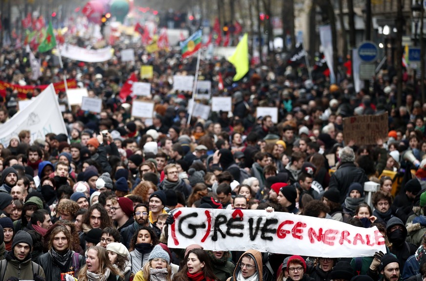 epa08046742 Protesters hold a sign reading (G)reve Generale (lit: General Strike and Dream) during a demonstration against pension reforms in Paris, France, 05 December 2019. Unions representing railw ...