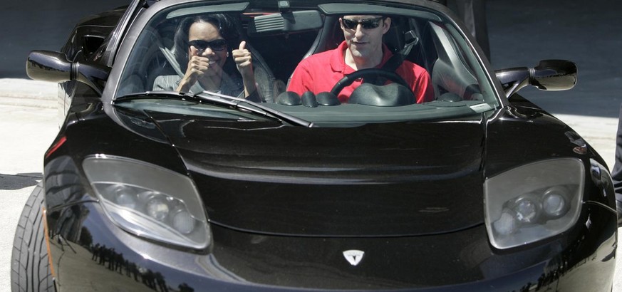 U.S. Secretary of State Condoleezza Rice, left, gives a thumbs up as she prepares to take a test ride on the 2007 Tesla Roadster electric car along with Tesla sales manager Tom O'Leary, right, during  ...